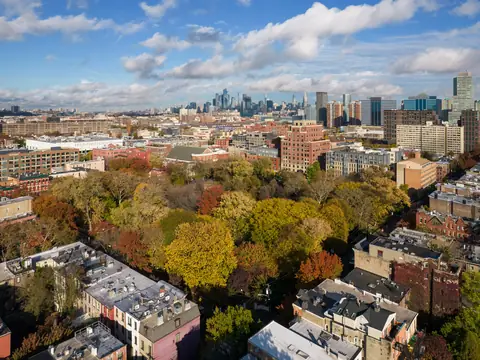 Flat roofs of joined brick rowhouses near Hamilton Park in Jersey City, seen from above