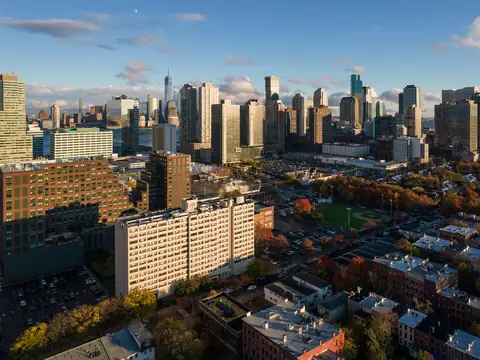 Downtown Jersey City from the air: towers behind blocks of older brick buildings