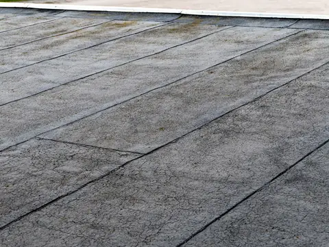 Lapped seams across an aging bitumen flat roof